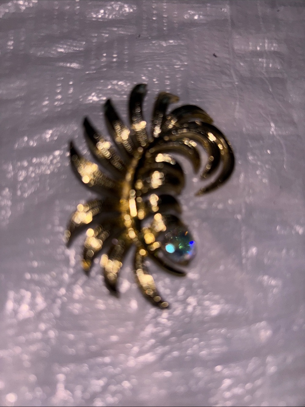 Gold Tone Floral Swirl Brooch with Iridescent Crystal